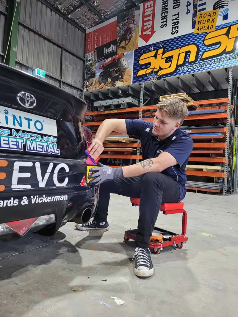 Applying-Sticker-800×1066-compressed